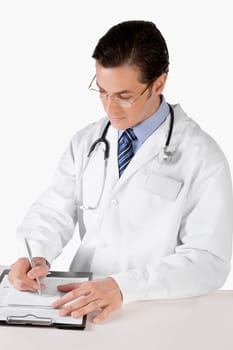 Doctor writing on a clipboard