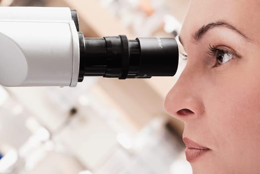 Female doctor working on a microscope in a laboratory