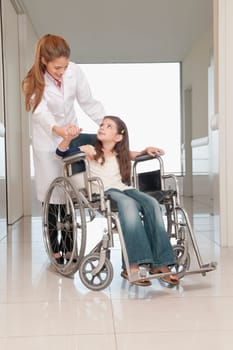 Female doctor with a patient in a wheelchair