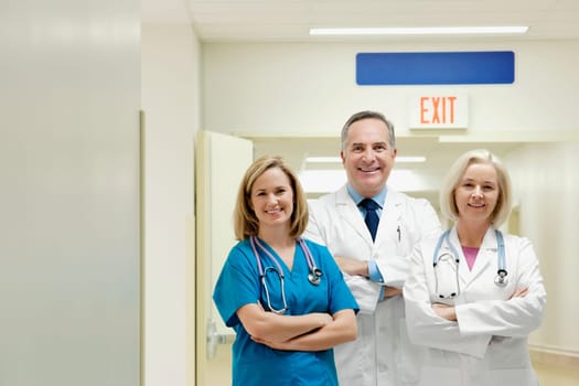 Doctors and a nurse smiling in a hospital