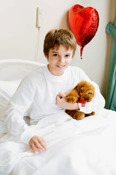 Portrait of a boy sitting on a hospital bed