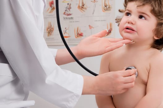 Doctor examining a baby boy with a stethoscope