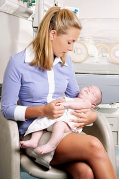 Woman carrying her newborn baby