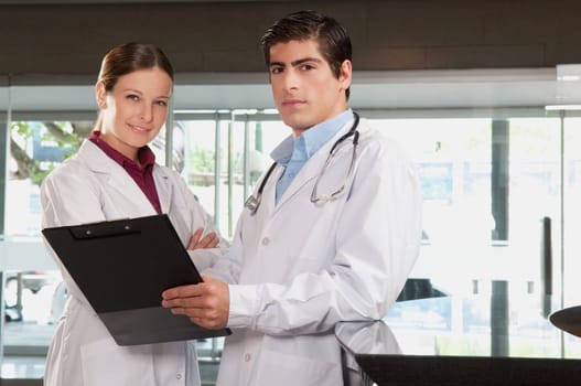 Two doctors with a clipboard