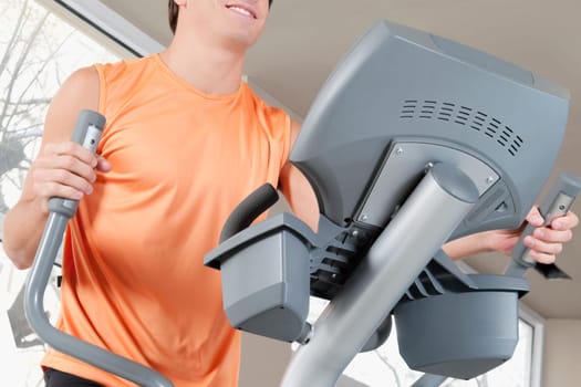 Man exercising on a stepping machine in a gym