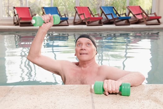 Man exercising with dumbbells in a swimming pool