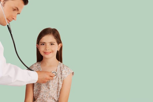 Doctor examining a girl with a stethoscope