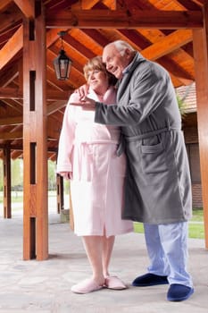 Man standing with his arm around a woman at a rehabilitation centre