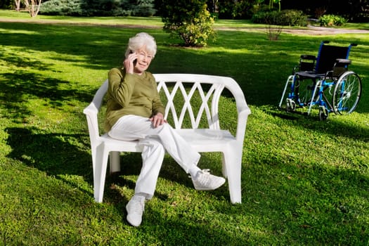 Woman sitting in a park and using a mobile phone