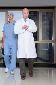 Doctor and a surgeon walking in the hospital corridor