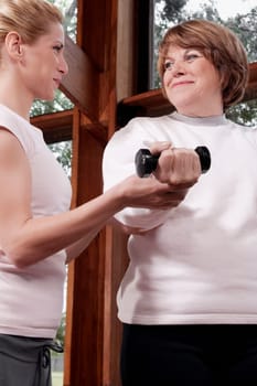 Physiotherapist helping a disabled woman in exercising