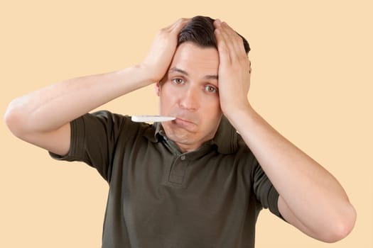 Man checking his temperature with a thermometer