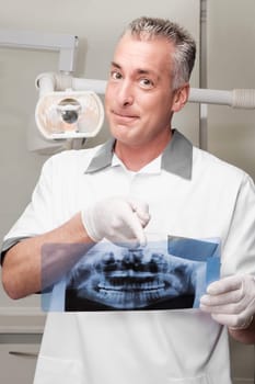 Dentist examining an X_Ray report