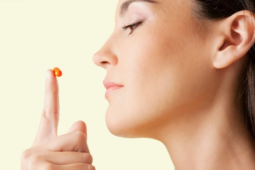 Close_up of a woman looking at a capsule