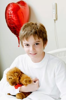 Portrait of a boy sitting on a hospital bed
