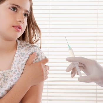 Doctor giving an injecting to a girl