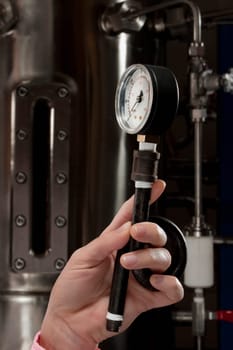 Female doctor holding a pressure gauge in a laboratory