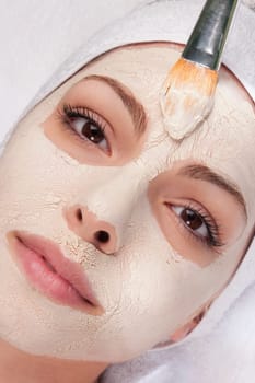 Woman applying face pack