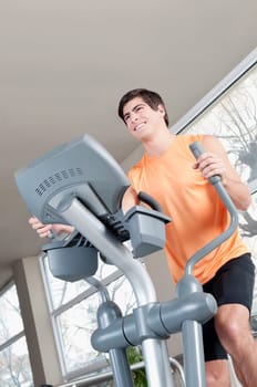 Man exercising on a stepping machine in a gym