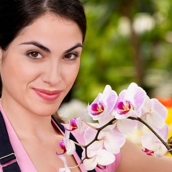 Portrait of a woman smiling in a greenhouse