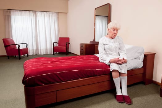 Woman sitting on the bed in a rehabilitation center