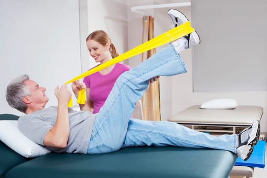 Physiotherapist assisting a patient in exercising