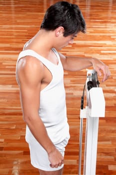 Man measuring his weight on a weighing scale