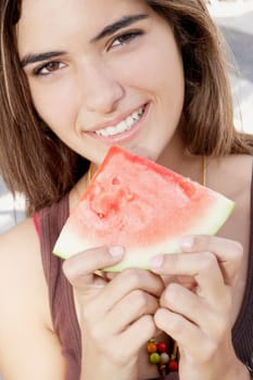 Portrait of a woman holding a slice of watermelon