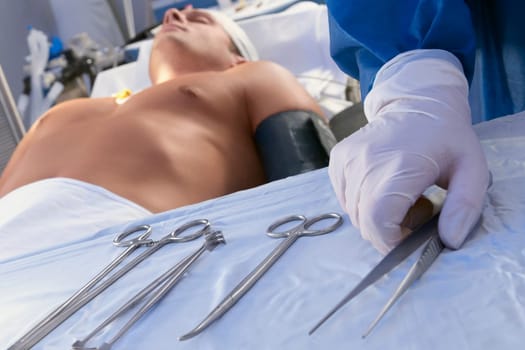 Surgeon holding surgical scissors in an operating room