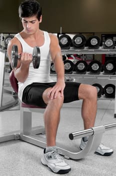 Man exercising with dumbbells in a gym