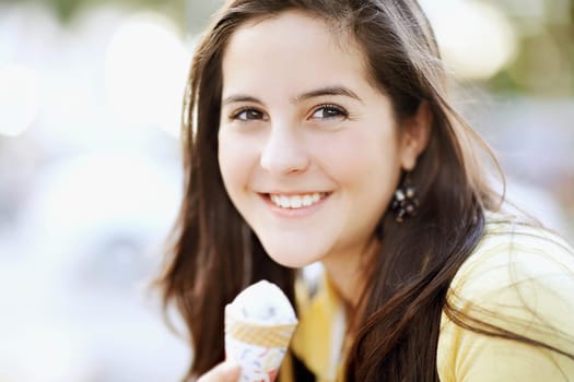 Portrait of a teenage girl eating an ice cream