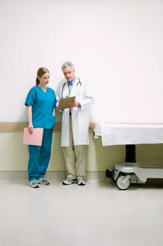 Doctors discussing a medical report with a nurse