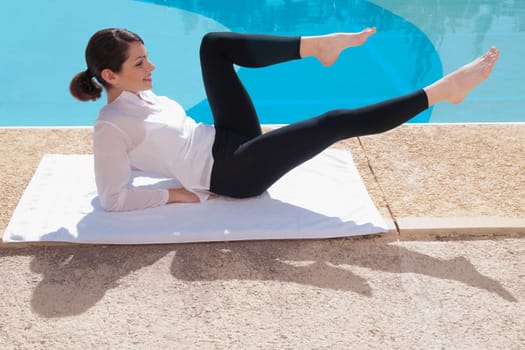 Woman exercising at the poolside