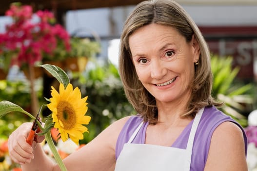 Female florist pruning flowers