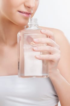 Woman smelling aromatherapy oil
