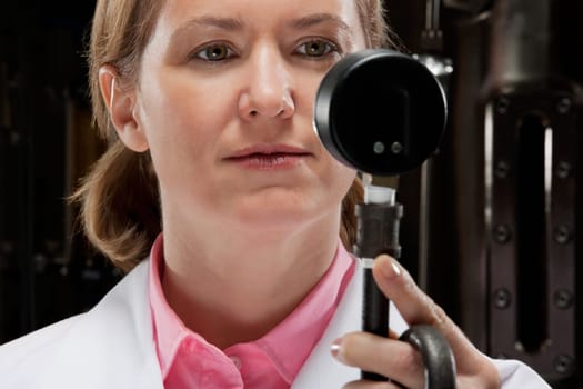 Female doctor holding a pressure gauge in a laboratory