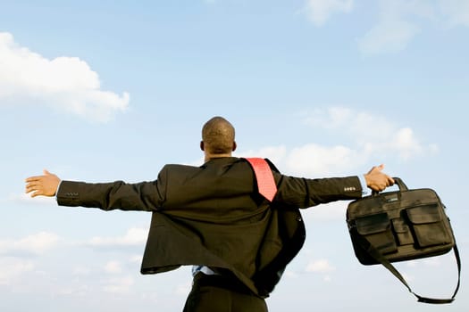 Businessman standing with his arm outstretched
