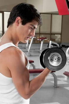 Man exercising with dumbbells in a gym