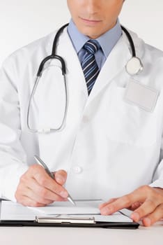 Doctor writing on a clipboard