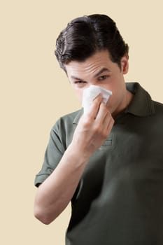 Portrait of a man blowing his nose