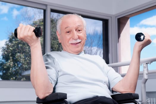 Disabled man exercising with dumbbells