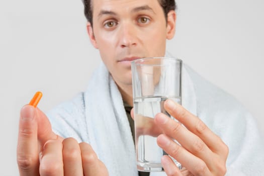 Portrait of a mid adult man taking medicine