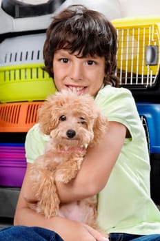 Boy carrying a puppy in a supermarket