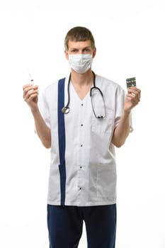 Portrait of a doctor holding a syringe with medicine in one hand and pills in the other hand, isolated on white background