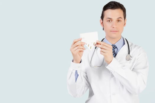 Portrait of a doctor holding a medicine pack