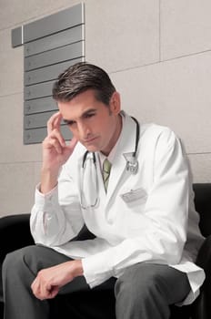 Doctor sitting on a chair and thinking