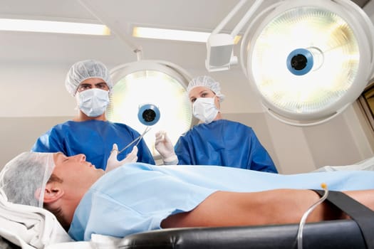 Two surgeons operating a patient in an operating room