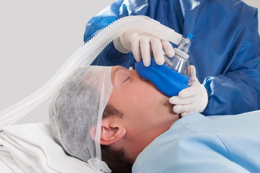 Doctor anaesthetizing a patient in an operating room