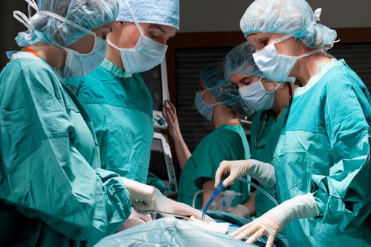 Surgeons performing a surgery in an operating room