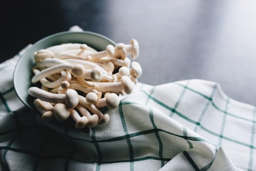 Cooking white mushrooms on the dark gray background. High quality photo